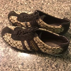 Brown Coach tennis shoes.